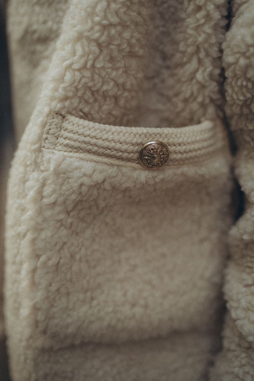 Close-up of a wool jacket pocket showing the substantial construction, thick binding, and hardware that characterize a Cruiser-tier workwear piece.