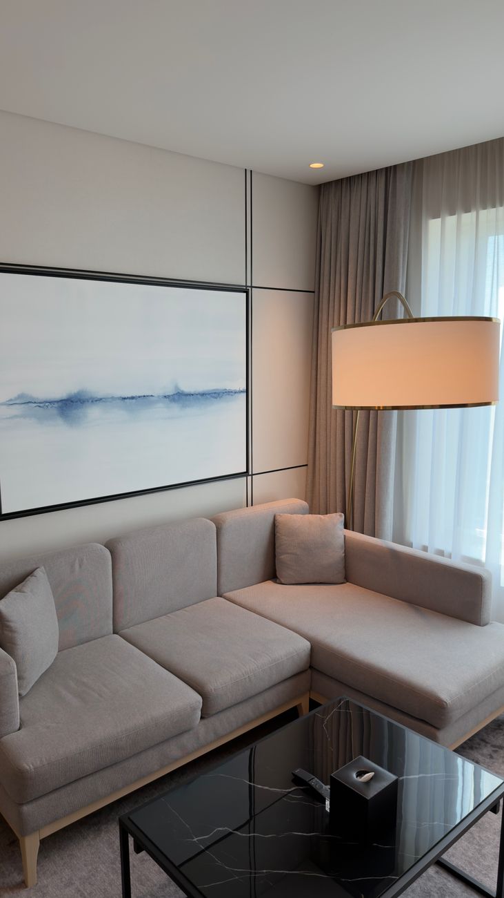 A modular sectional sofa arranged in an L-shape in a minimal room with soft natural light.